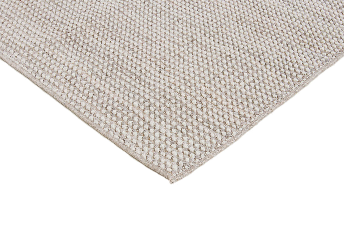 Textured area rug in stone and beige hues 
