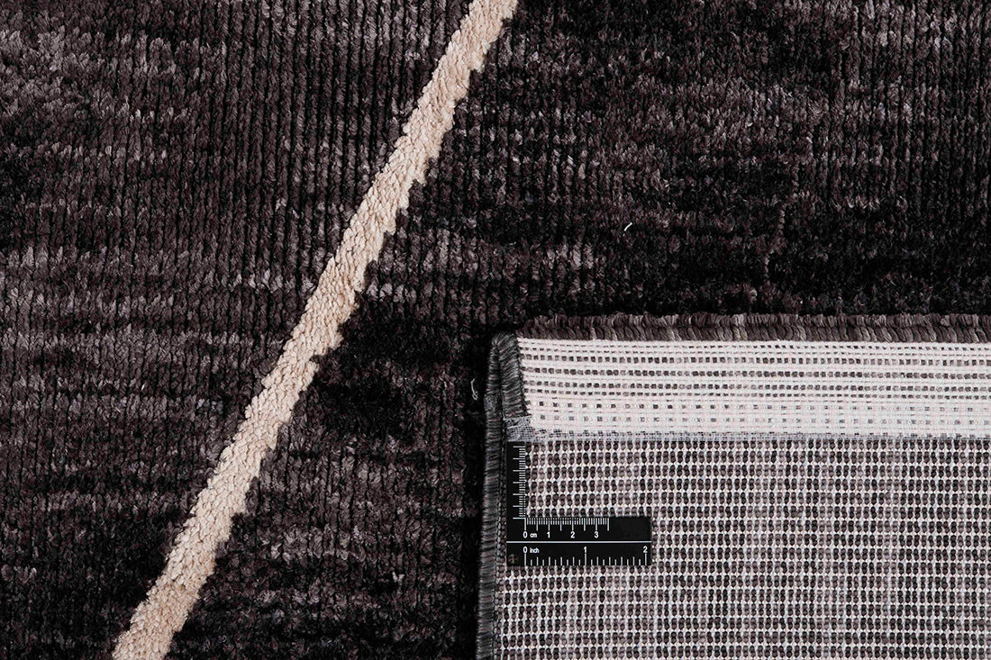 Black rug with minimal cream geometric pattern
