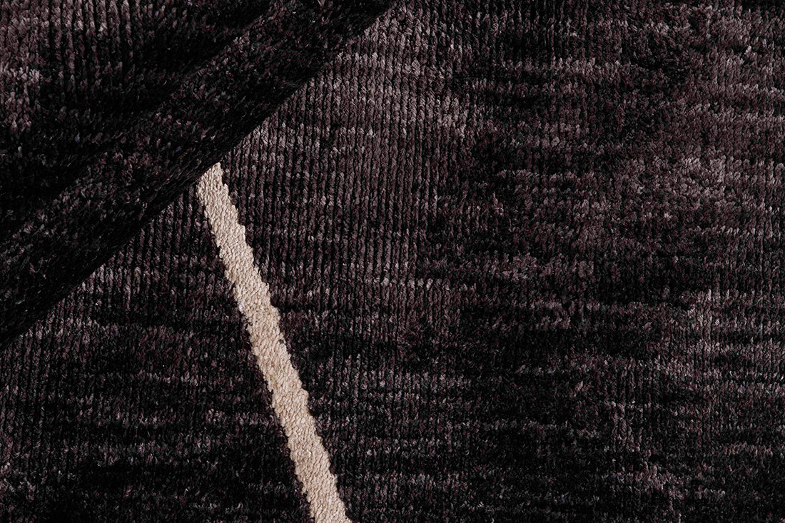 Black rug with minimal cream geometric pattern

