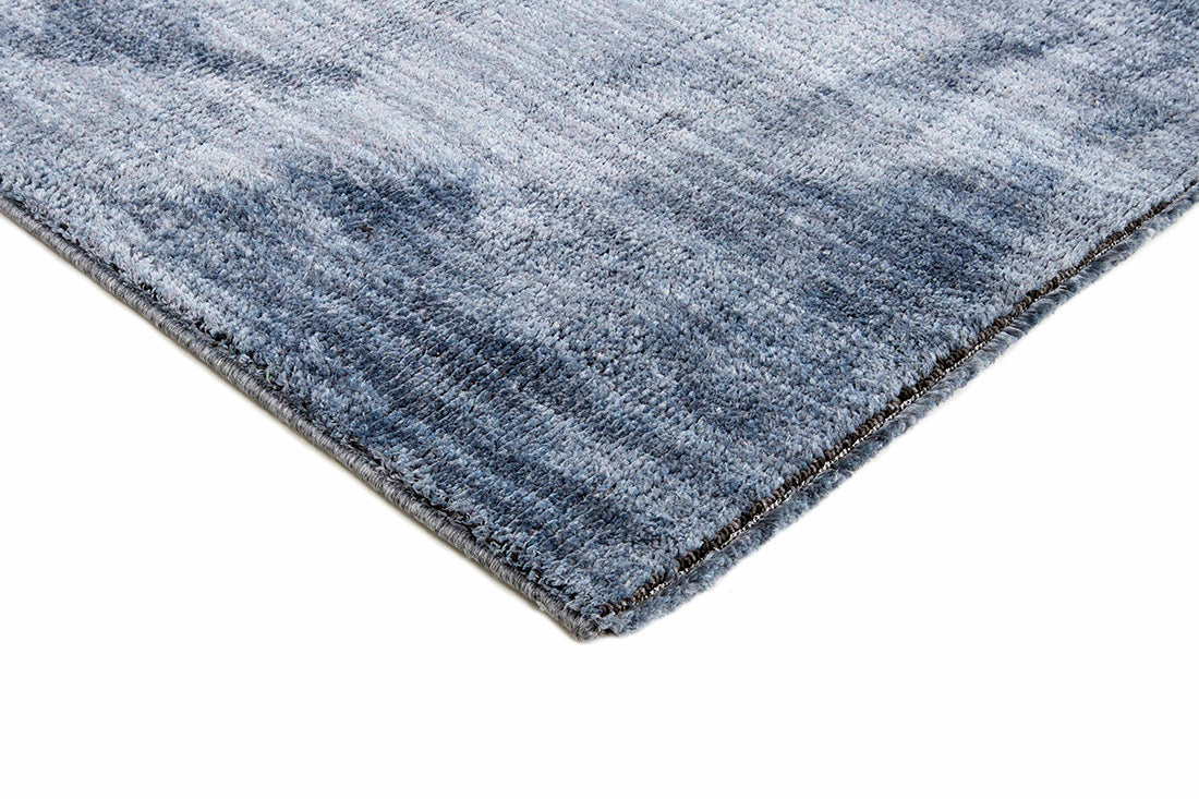 Blue toned rug with blue striped pattern
