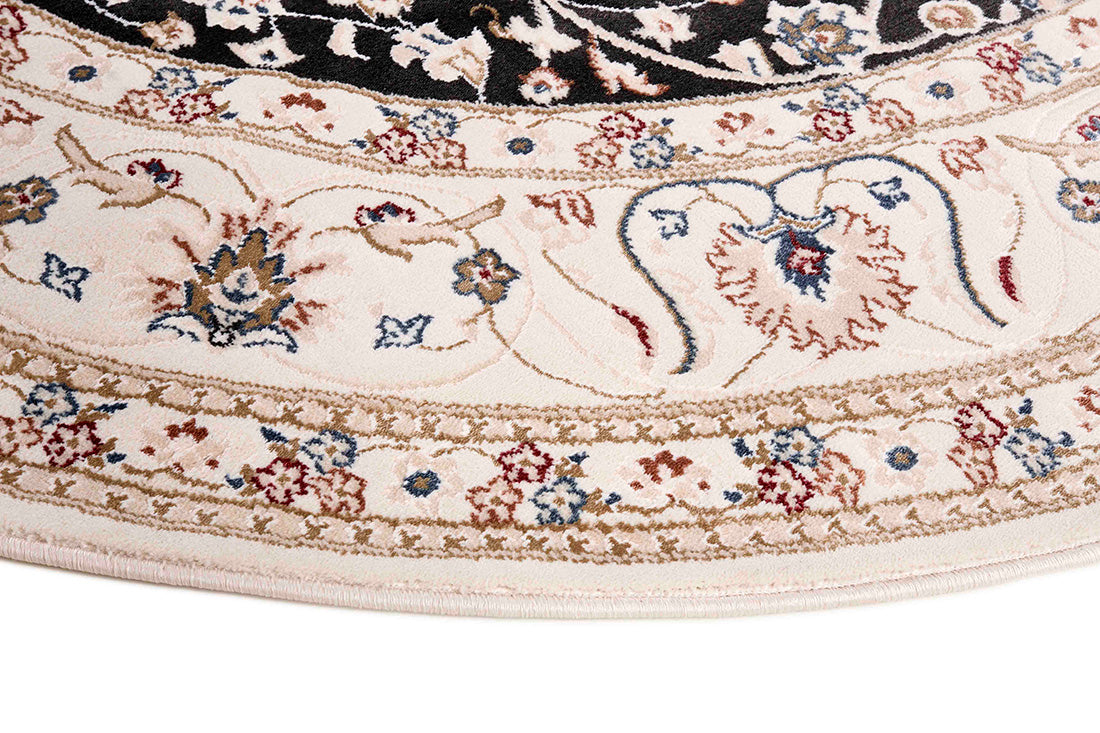 Traditional Persian Nain style round rug. White with a border and a black medallion pattern.
