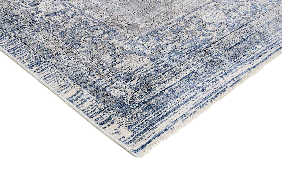 Blue rectangle rug with abstract pattern and classic bordered design
