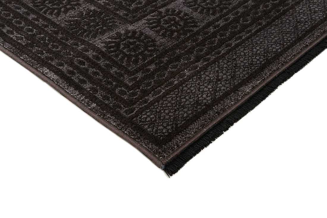 Traditional Bokhara style rug with border. In shades of black
