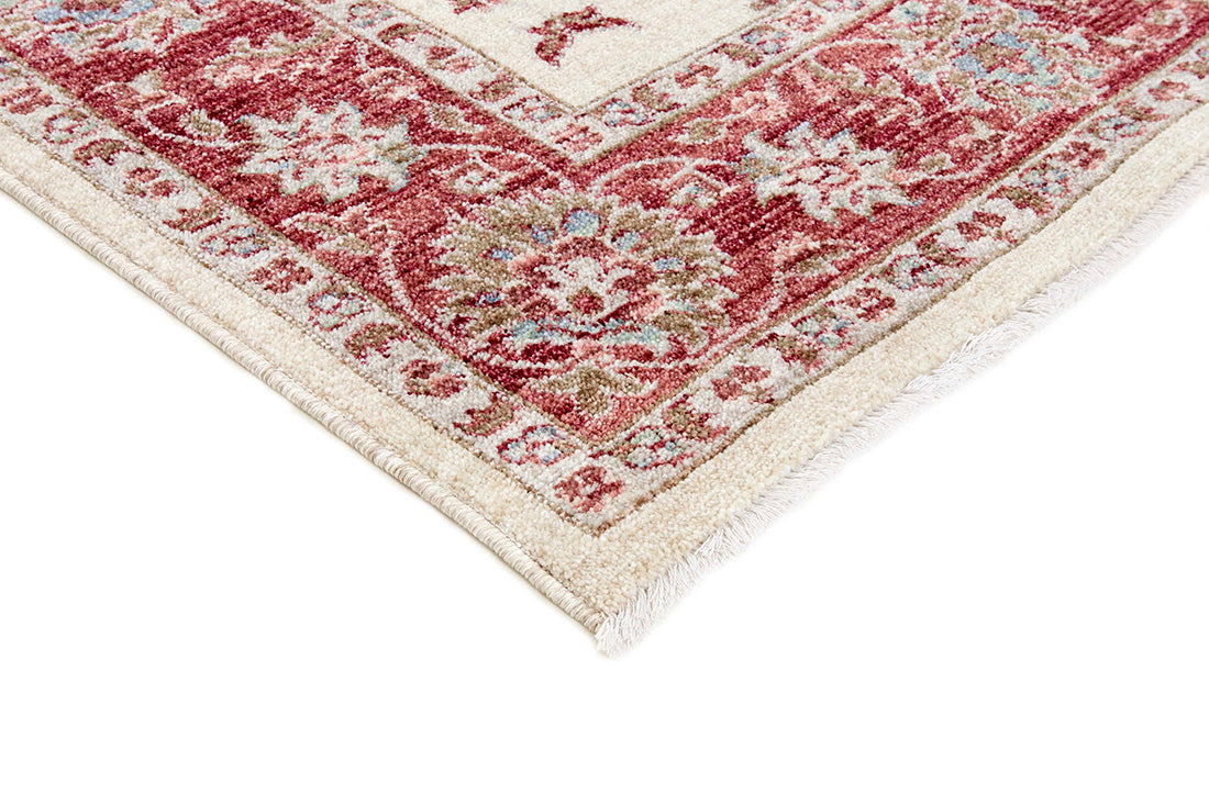 Traditional red bordered Ziegler-style rug with floral motif 

