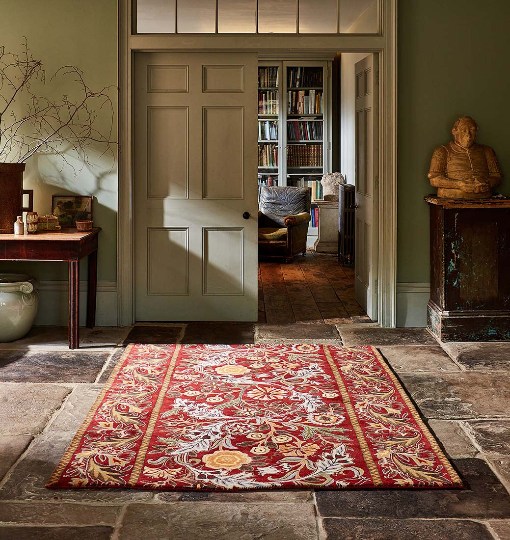 red wool rug with multicolour floral design
