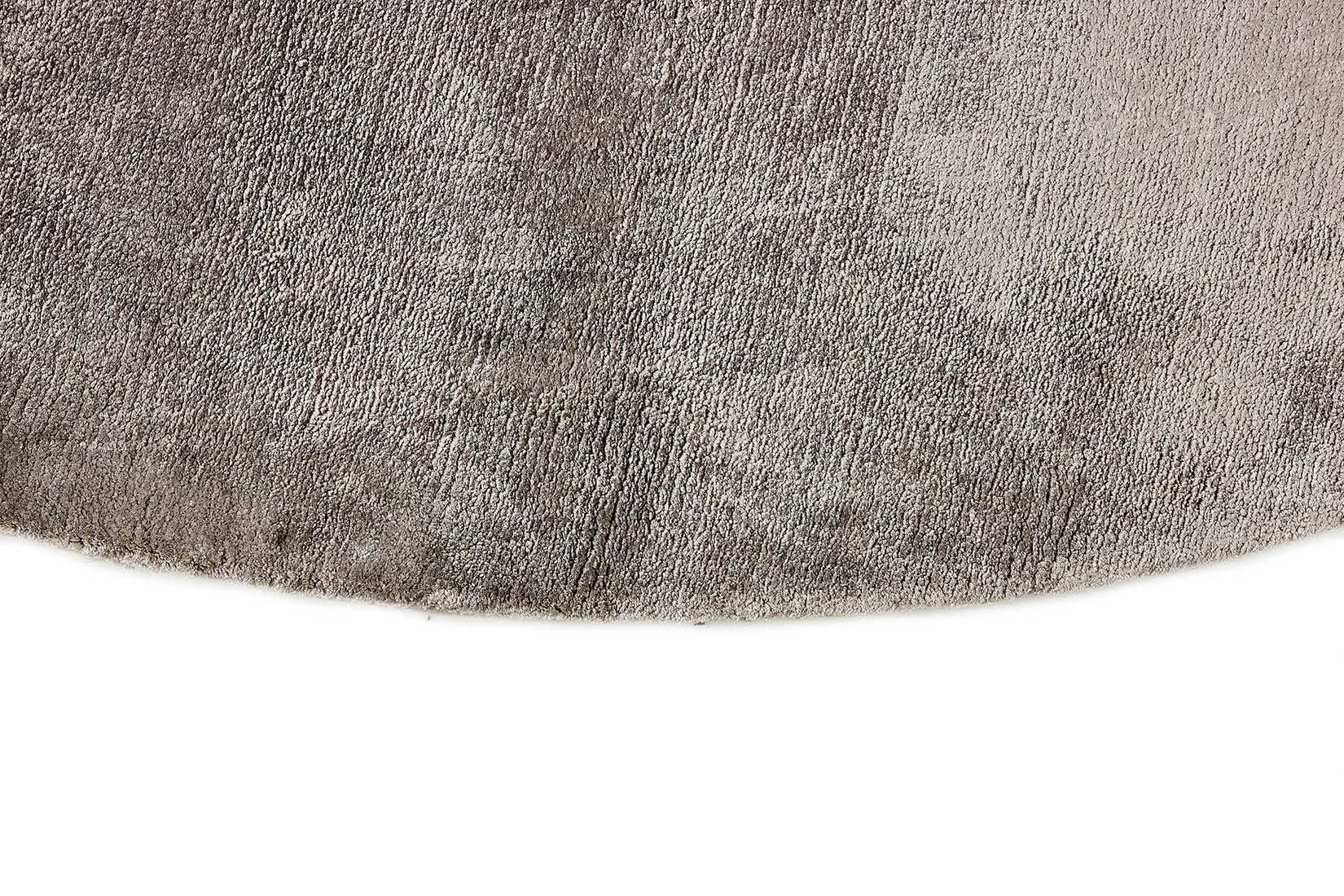 large plain grey and black viscose circle rug
