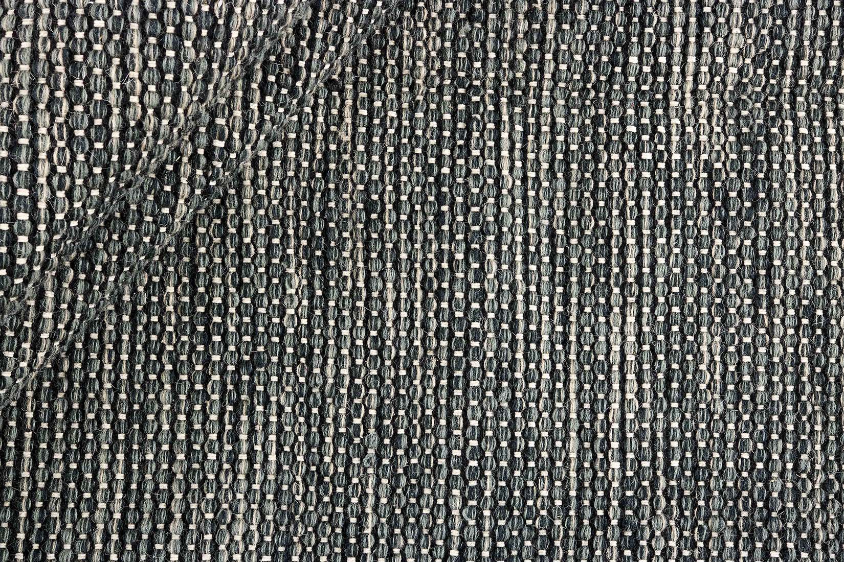 plain black and green flatweave wool rug
