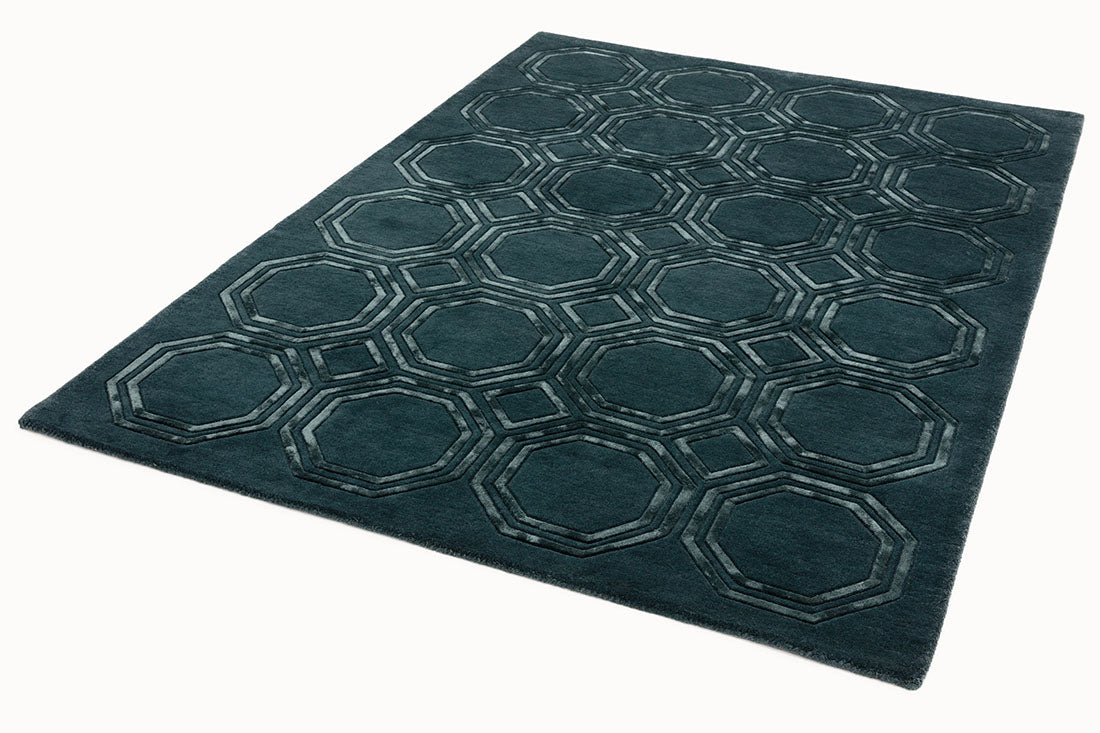 green rug with a geometric pattern