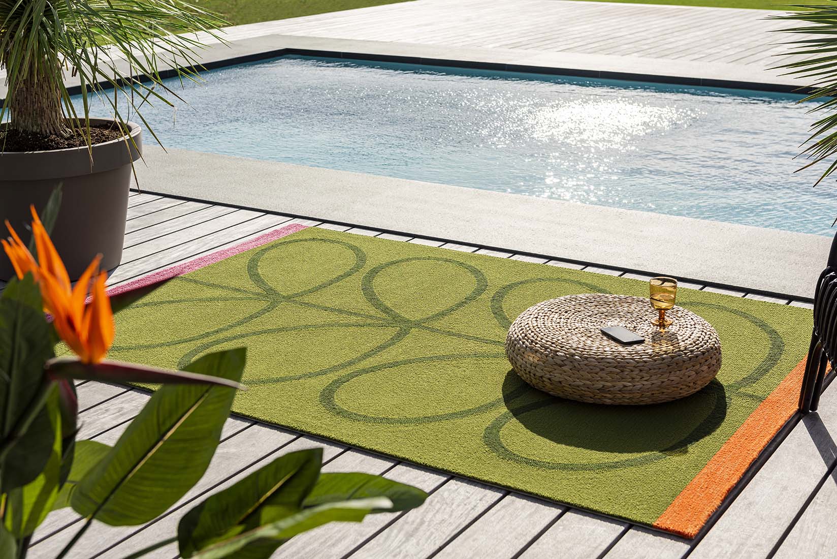 green indoor/outdoor rug with oversized floral print
