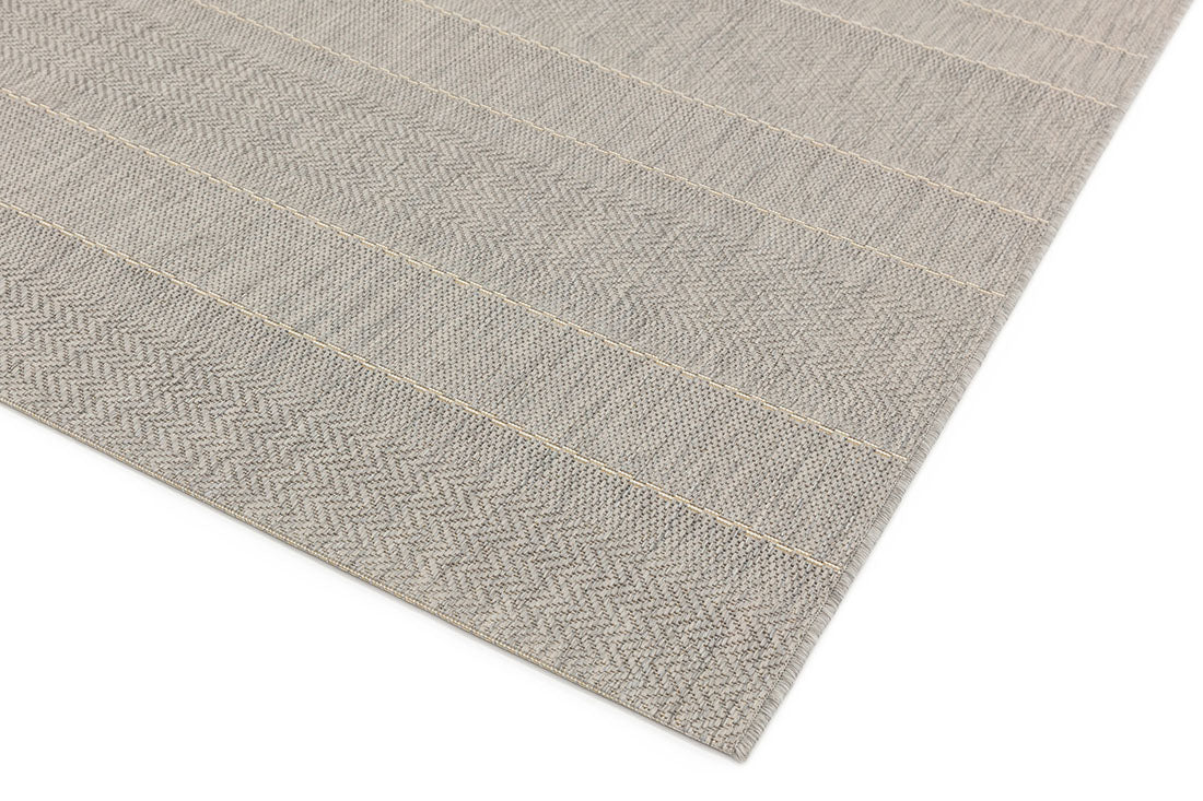 Woven beige and white rug with stripe pattern