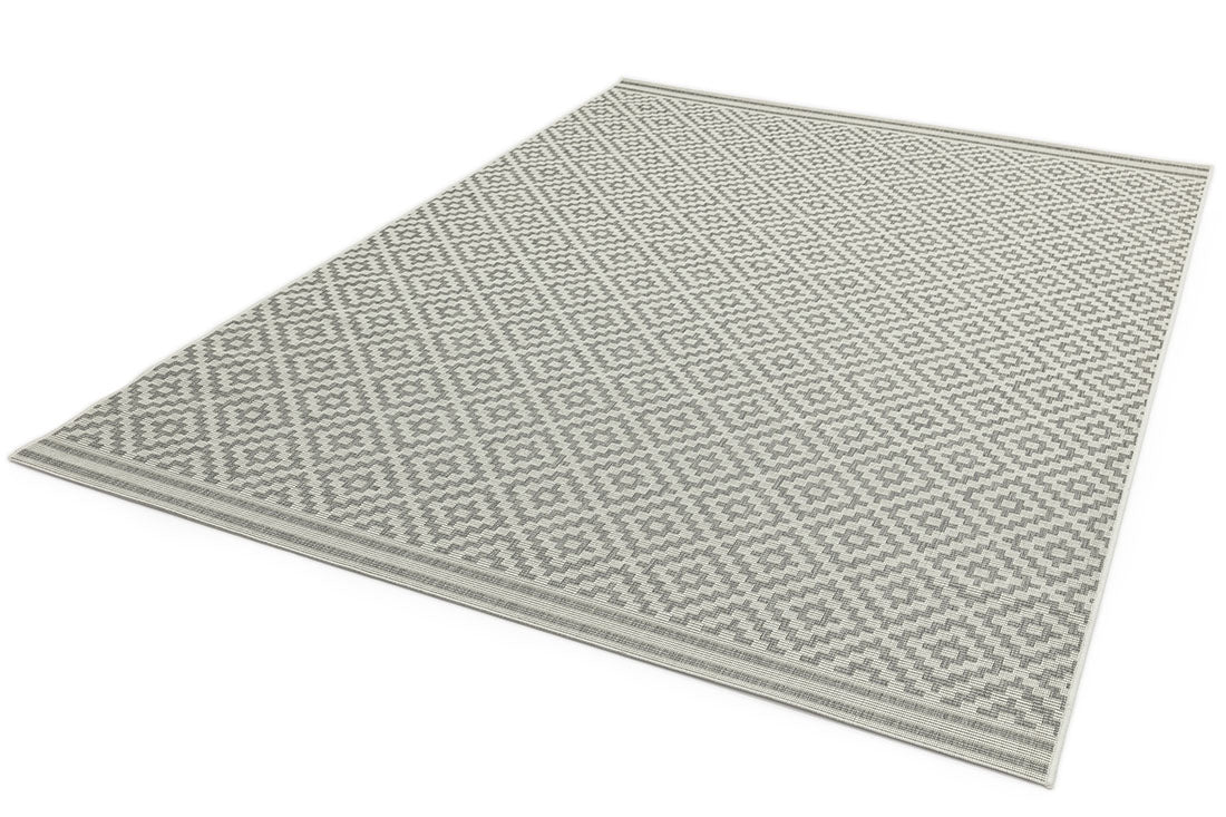 Woven grey and white rug with a modern geometric diamond pattern