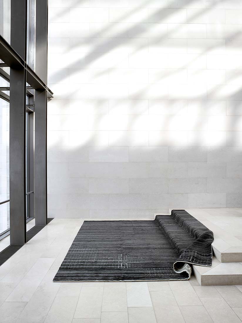 dark grey area rug with abstract design
