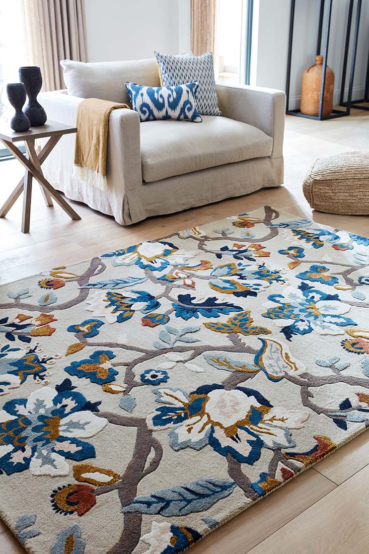 stone coloured wool and viscose rug with multicolour floral design
