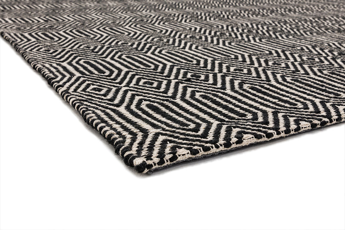 black and white woven rug with aztec chevron pattern