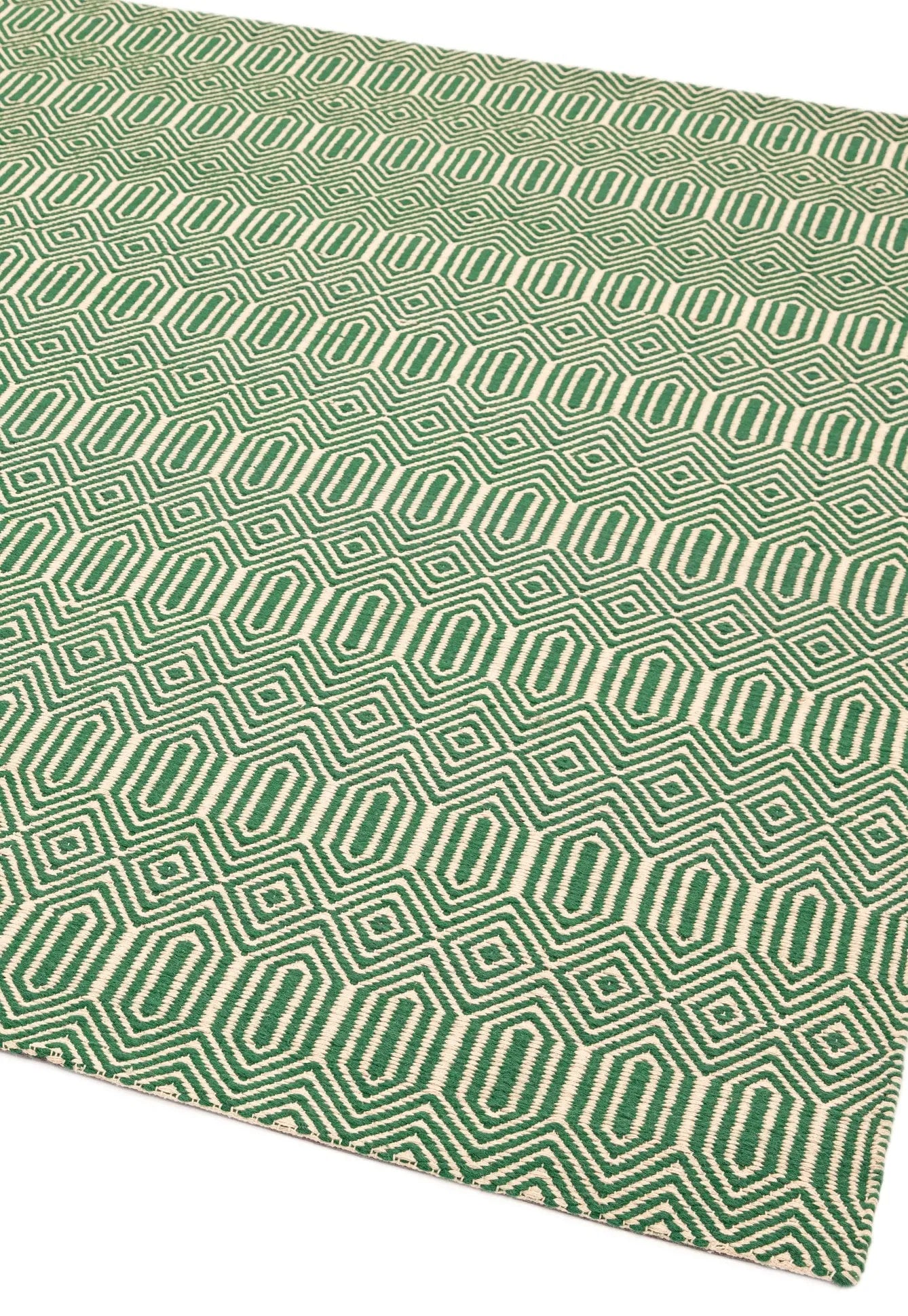 Green woven rug with aztec chevron pattern