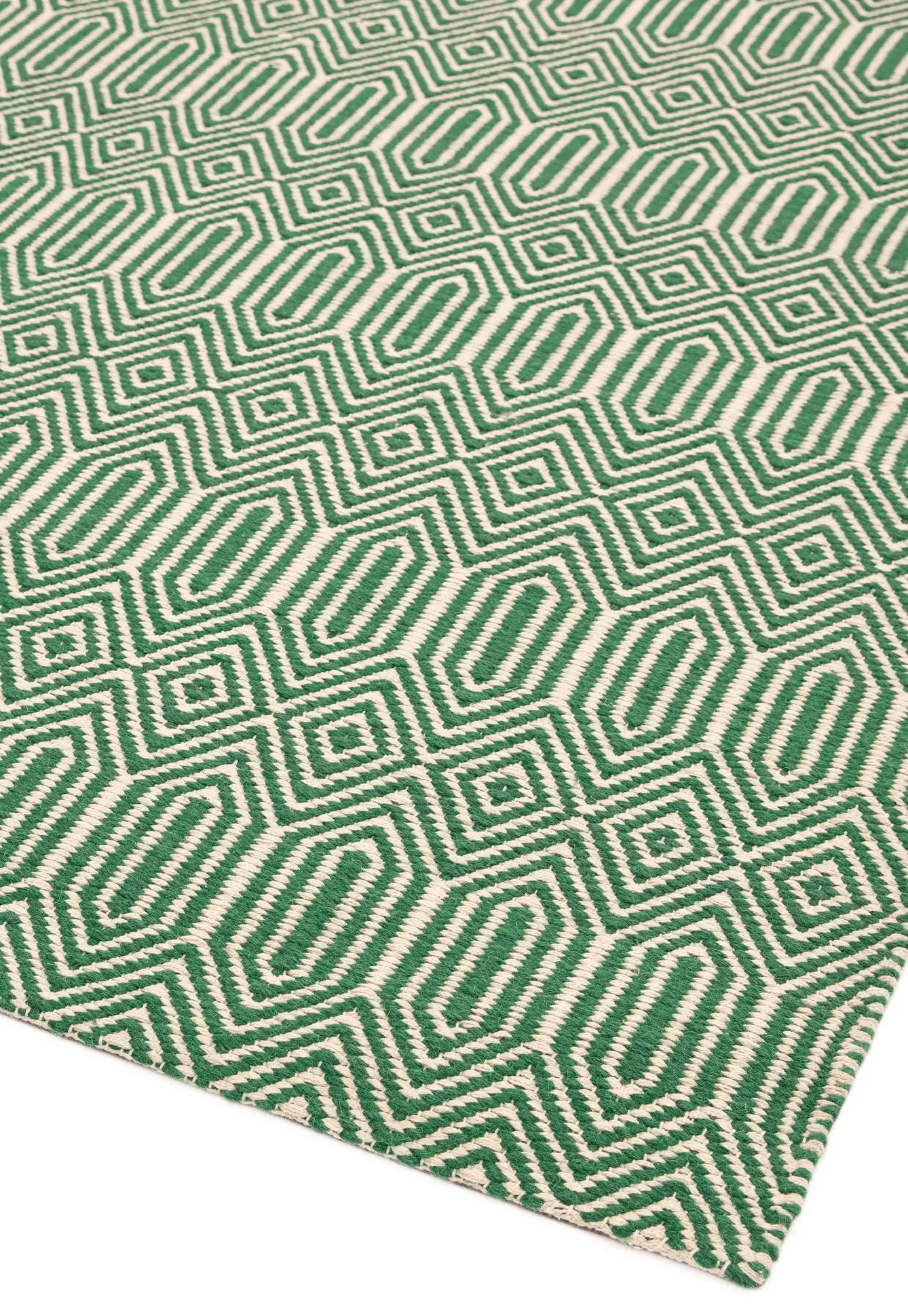 Green woven rug with aztec chevron pattern