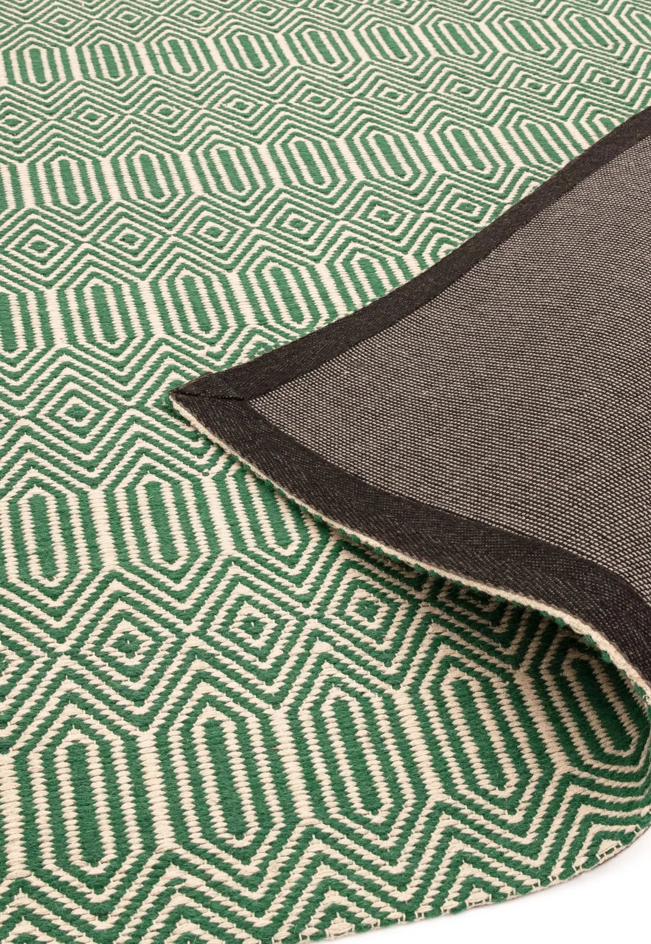 Green woven rug with aztec chevron pattern