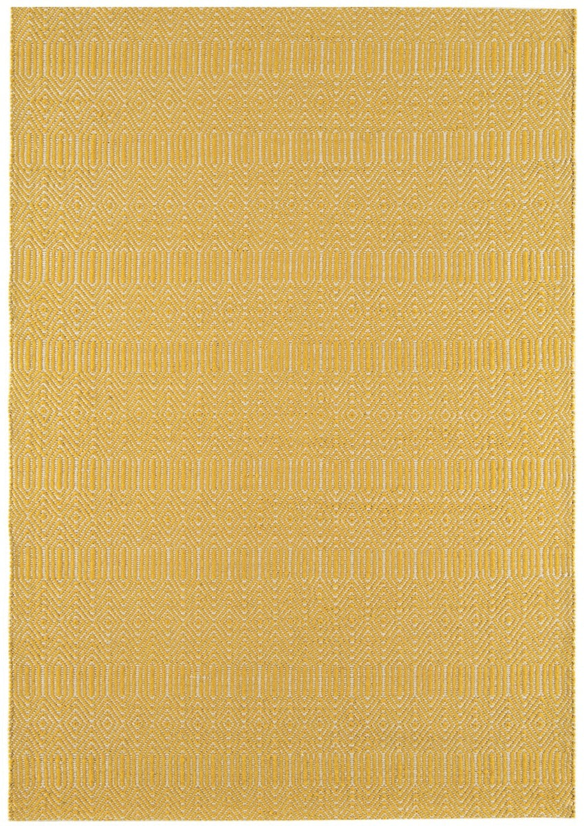 mustard yellow and white rug with a geometric aztec pattern