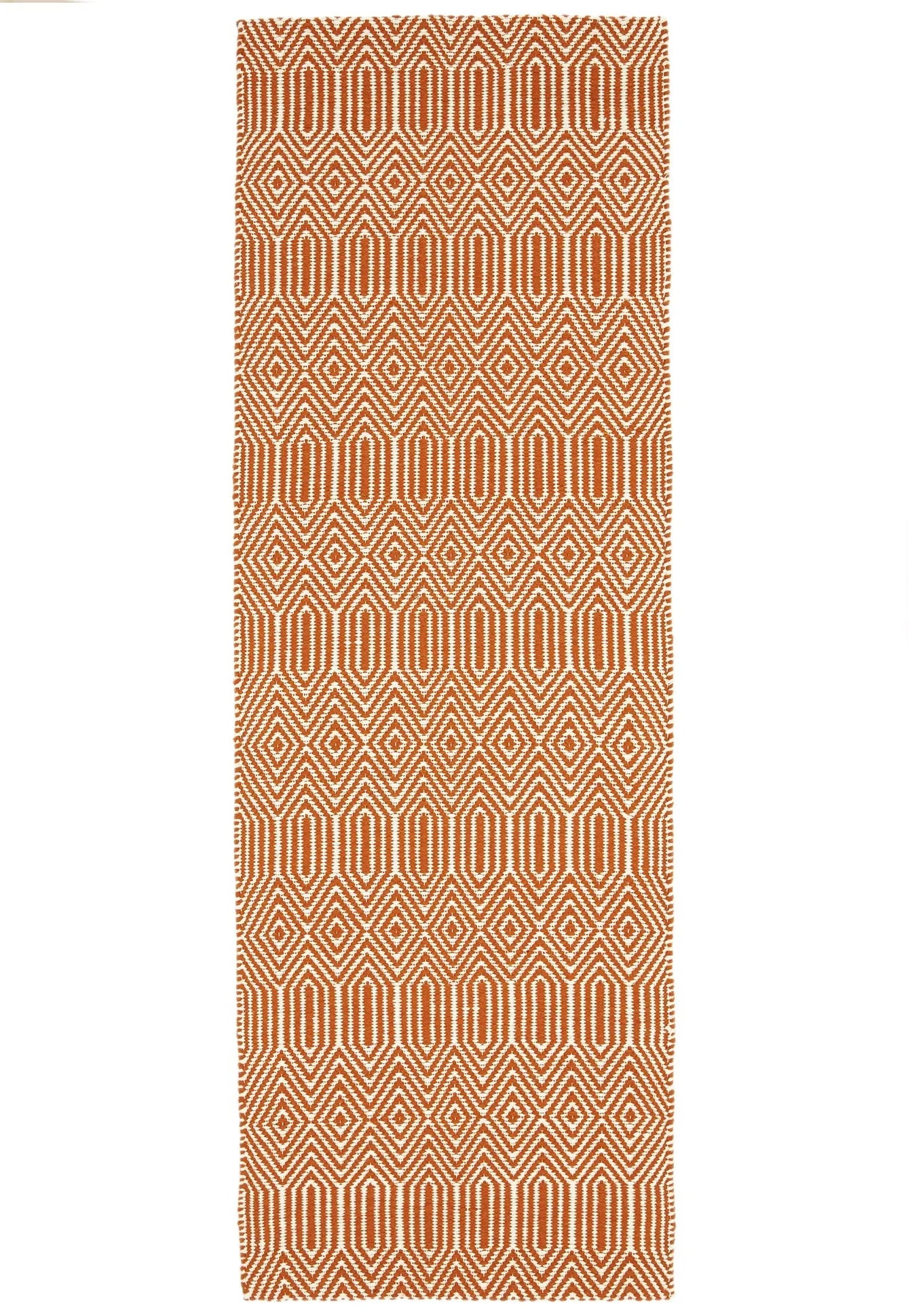 orange and white geometric runner with an aztec pattern