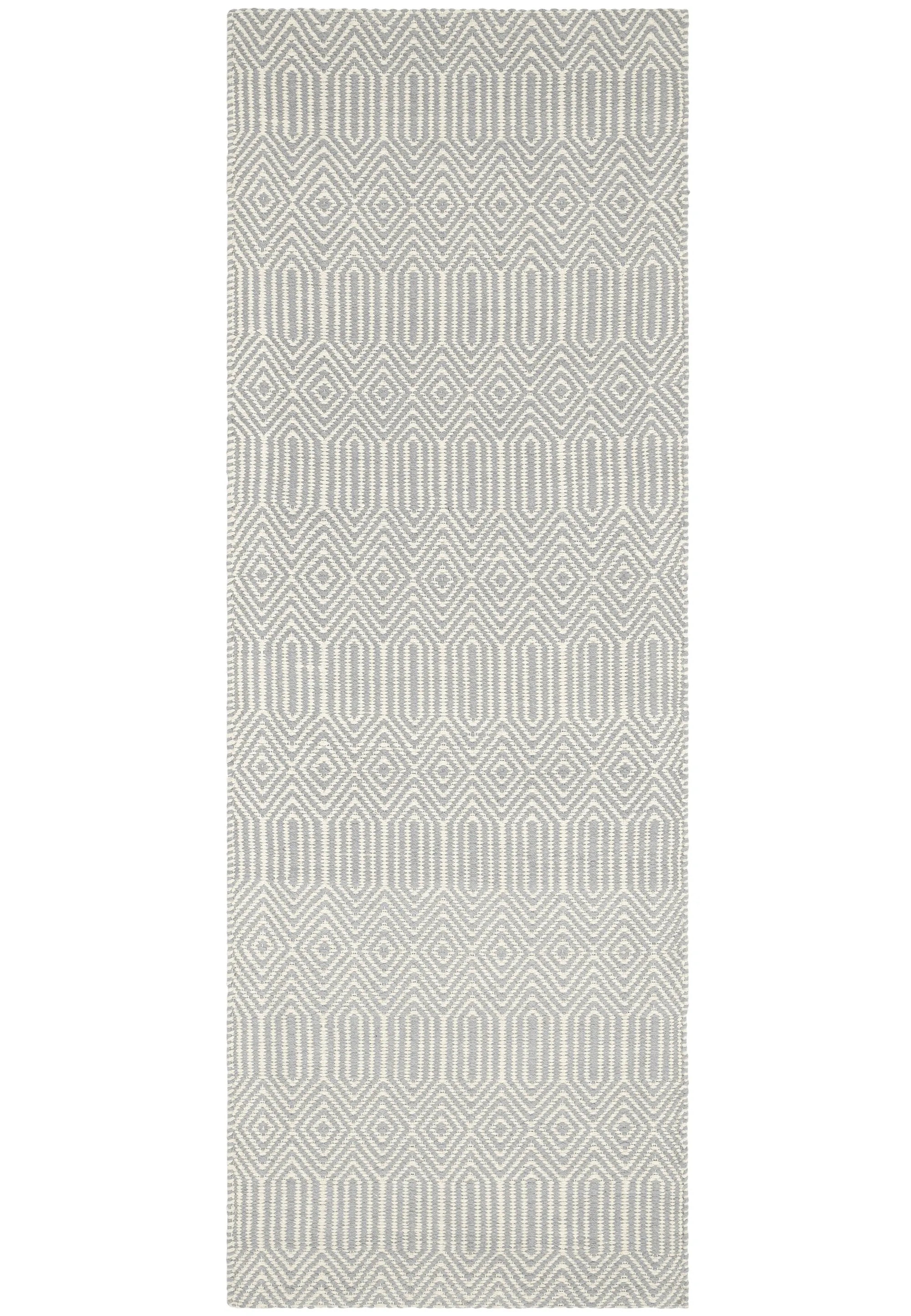 taupe and white runner with a geometric aztec pattern