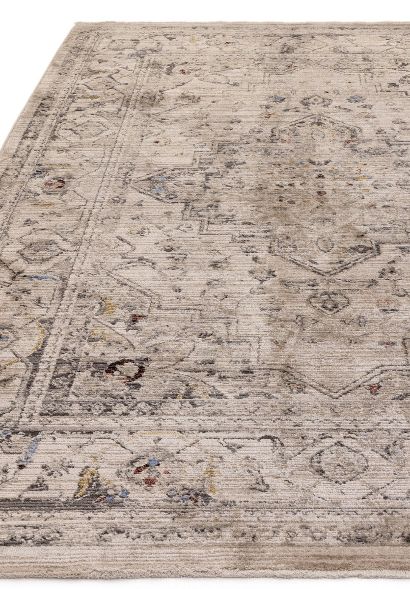 Vintage style distressed rug in beige with hints of blue and gold 
