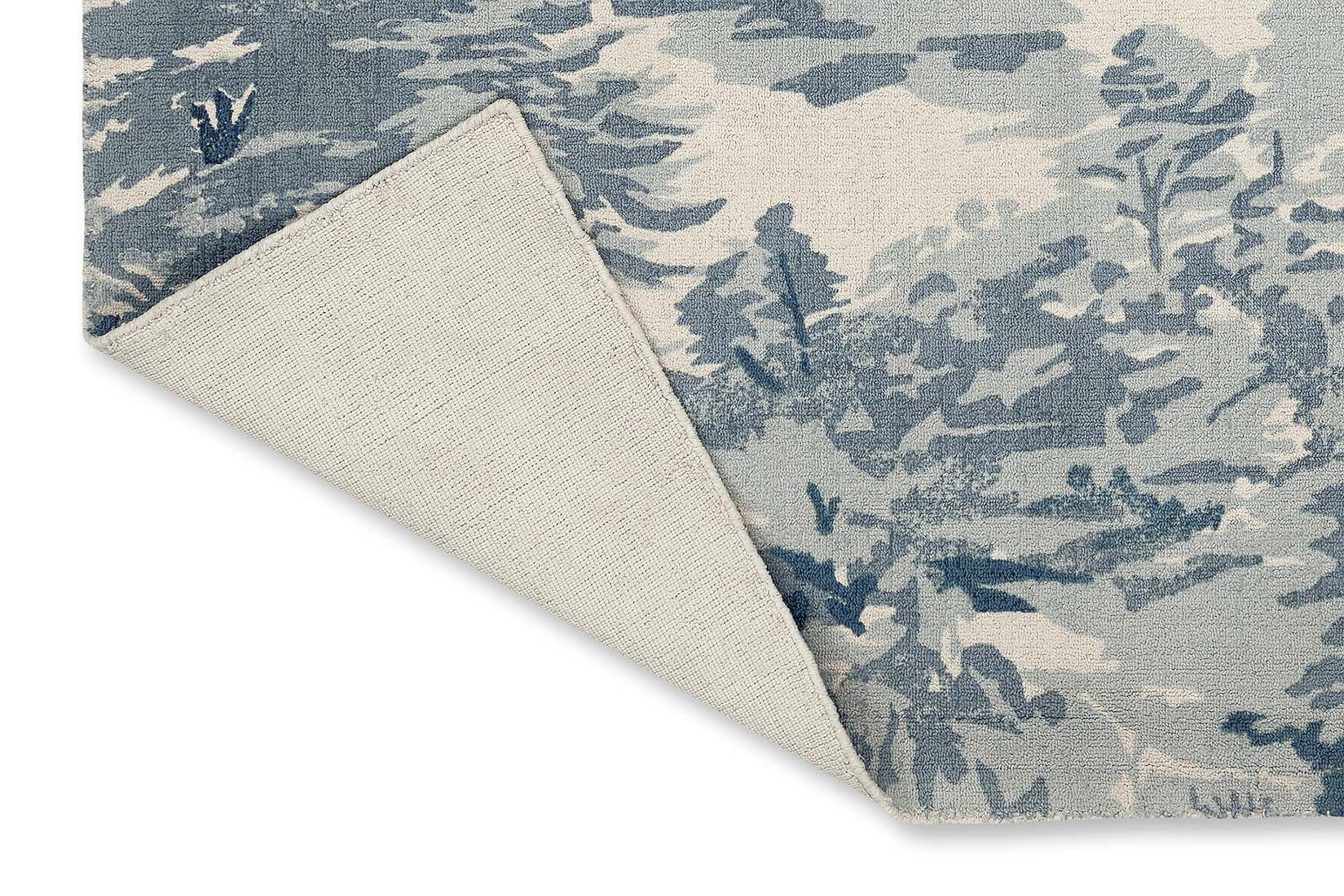 cream cotton rug with tree pattern in blue
