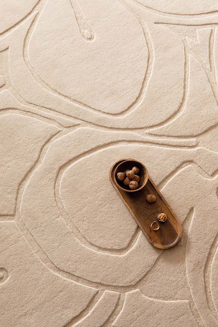 cream wool rug with shapes 

