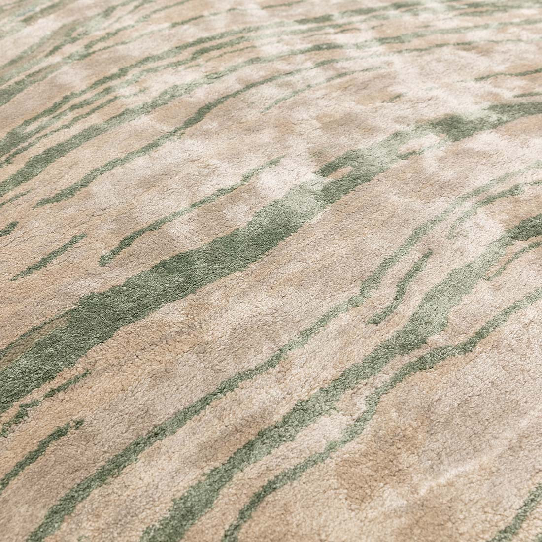 green and beige handtufted abstract rug in a marble design
