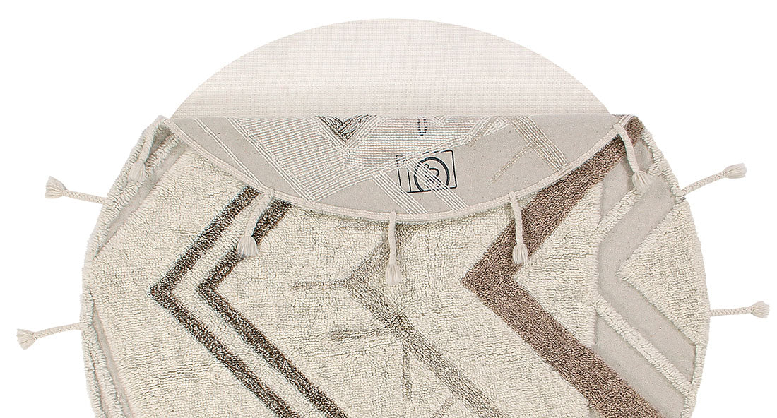 Washable Lorena Canals circle rug with a tribal design in beige