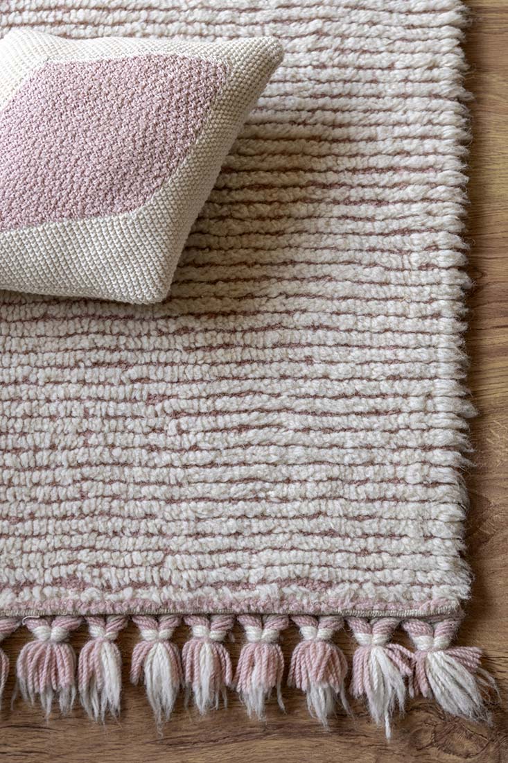 pink and cream textured wool rug
