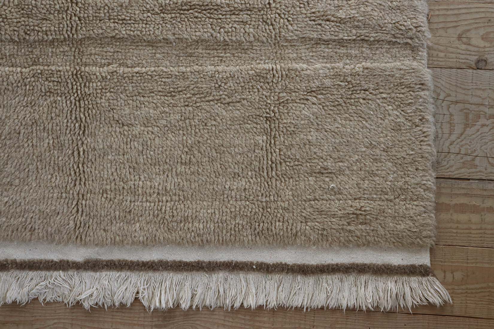 beige washable wool rug with textured detail
