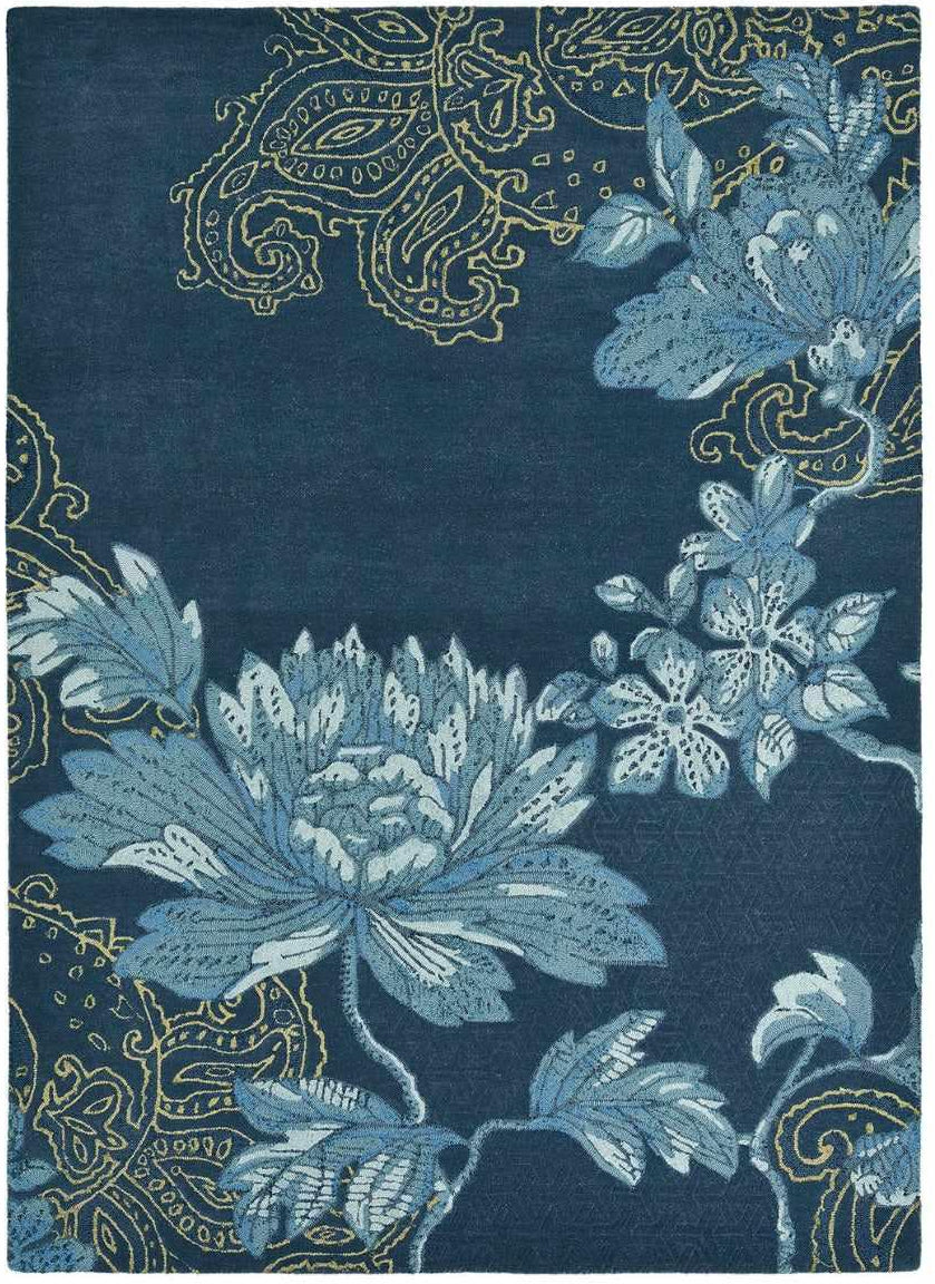 Rectangular navy blue rug with blue floral design, gold paisley pattern and engraved shapes