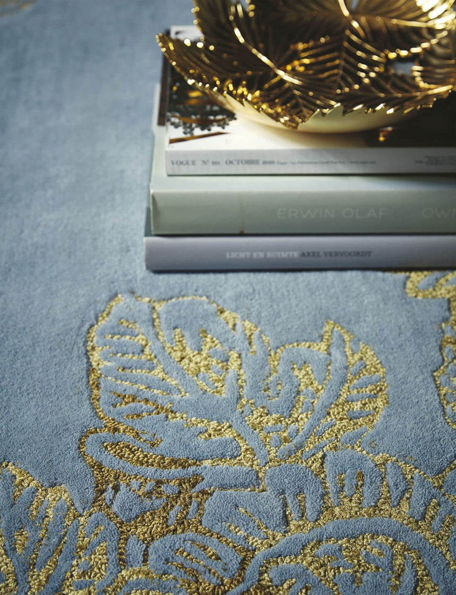 Rectangular blue rug with gold floral design