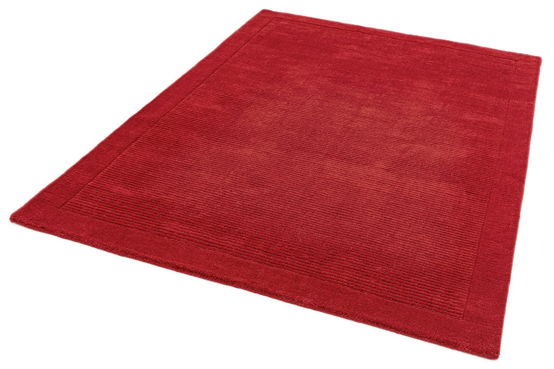A plain red rectangle-shaped wool rug with thin border.