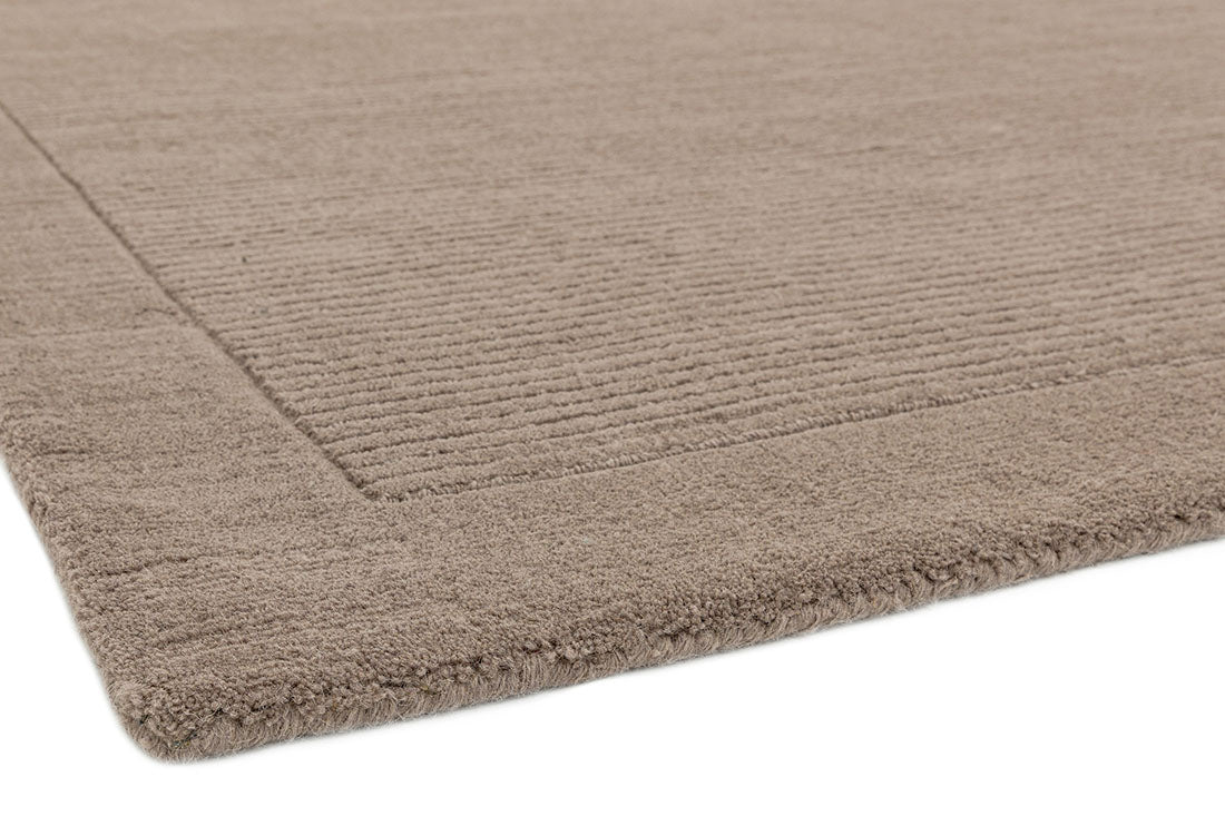 A taupe brown rectangle-shaped wool rug with thin border.